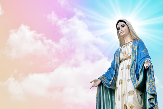 Statue of Our lady of grace virgin Mary with beautiful Sky Pastel with abstract colored background and wallpaper in sweet color. at Thailand.