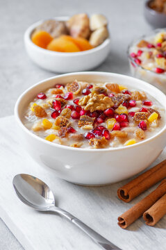 Traditional Turkish delicious mixed dessert, ashura (asure) with pomegranate seeds, walnut, apricot, Noah&rsquo;s pudding