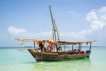 Photo sur Plexiglas Plage de Nungwi, Tanzanie Dhow Fishing Boat at low tide on Zanzibar island, Tanzania