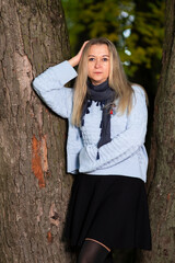 Seasonal and People Ideas. Winsome Caucasian Beautiful Young Woman Walking in Autumn Park  Outdoors.