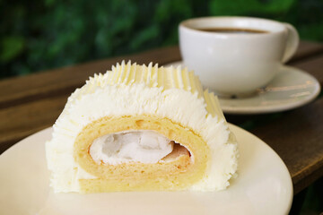 Closeup a Slice of Young Coconut Roll Cake Served with Coffee on Tea Table