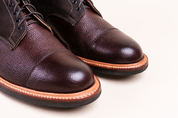 Closeup of Toes of Premium Dark Brown Grain Brogue Derby Boots Made of Calf Leather with Rubber...