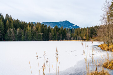 Schwarzsee lake in Kitzbuhel covered with ice and snow. Winter in Austria