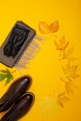 Flatlay Of Premium Dark Brown Grain Brogue Derby Boots Made of Calf Leather with Rubber Sole Placed With Yellow Maple Leaves And Scarf With Gloves