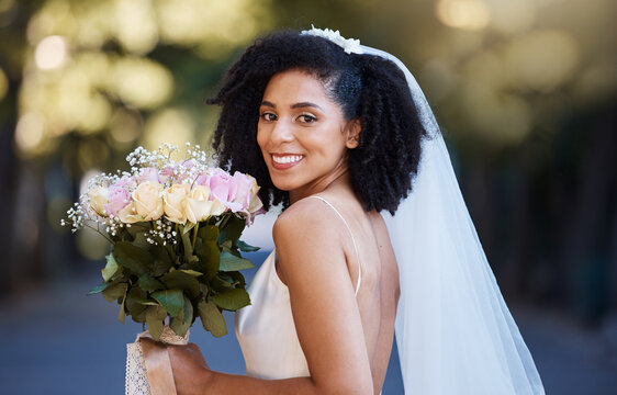 Bride, face and black woman with wedding and rose bouquet, happy in portrait with marriage and commitment outdoor. Event, celebration and happiness with smile in park married and Spring fashion