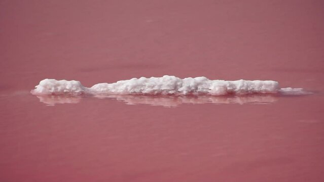 Pink salt crystals. Natural pink salt lake texture. Salt mining. Extremely salty pink lake, colored by microalgae with crystalline salt depositions