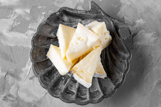 Cheese camambert in plate on gray background