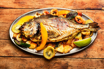 Baked carp with fruit.