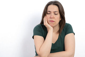 Fototapeta premium pensive woman looking at the ground with her hand on her face