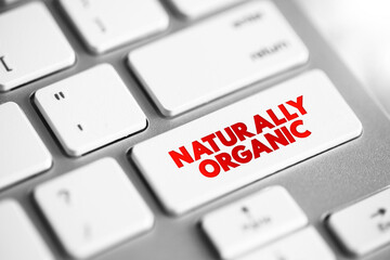 Naturally Organic - foods are grown without artificial pesticides, fertilizers, or herbicides, text concept button on keyboard