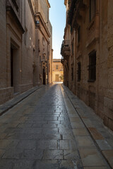 Vertical photo with a narrow street view of Mdina, Malta