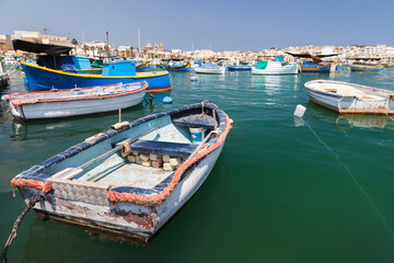 Small  Maltese fishing boats are anchored at Marsaxlokk, Malta