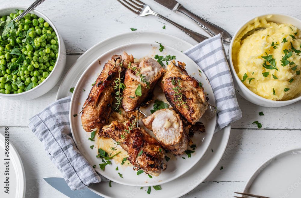 Wall mural Poultry roulades filled with cheese. Served with green peas and mashed potatoes on white background. Flat lay