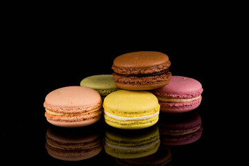 Colorful macaroon over black background