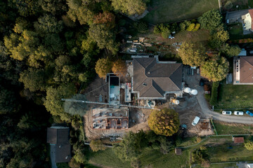 Aerial drone view of a construction site of an old villa with garden under renovation and an...