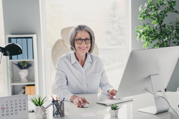 Photo portrait of mature grandma marketer ceo start up manager sitting boss chair wear specs modern...