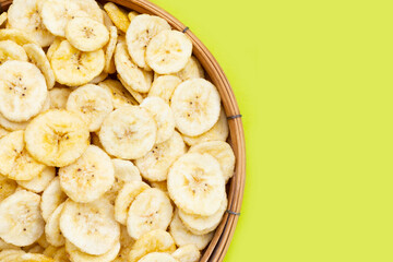 Banana slice chips on green background.