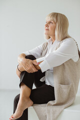 Studio portrait of gray-haired senior woman. Fashion photography in the studio. Probably an older female portrait. © dsheremeta
