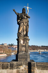 Fototapeta na wymiar Statue of St. John the Baptist on Charles bridge, Prague. Czech Republic.