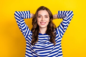 Photo portrait of lovely young lady arms behind head have rest sleepy wear trendy striped outfit isolated on yellow color background