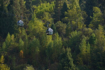 Almaty, Kazakhstan - 09.16.2022 : The cabs of the funicular go along the forest in the mountainous area of Medeo.