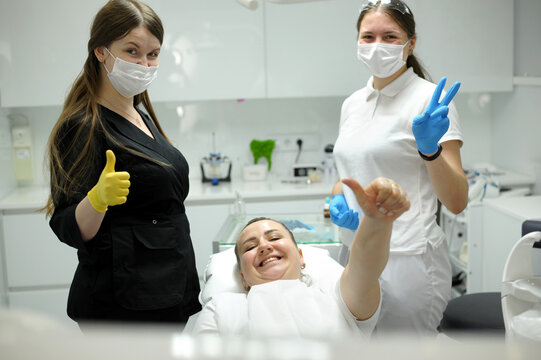 Dental Office Satisfied Patient Showing Thumbs Up Big Class She Liked Service New Technology Doctor And Assistant In Masks Are Also Happy With Result Of Work Smile Joy Dentist In Black White