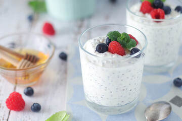 Greek yogurt in glasses with berries and quinoa