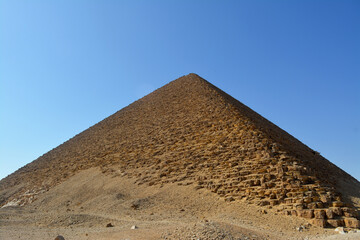 Obraz na płótnie Canvas The red north pyramid of Dahshur of king Sneferu, named for the rusty reddish hue of its red limestone stones, also called the bat pyramid, it contains burial chambers, vintage retro ancient Egypt
