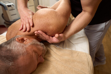 Elderly man undergoes a course of manual procedures