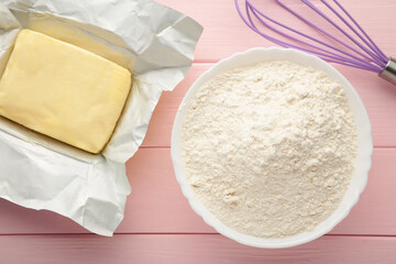 Ingredients for baking or cooking, egg flour, rolling pin butter, milk on a pink wooden background Cookie pie or cake recipe.