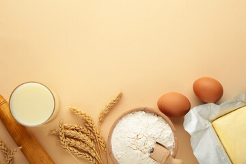 Ingredients for baking or cooking, egg flour, rolling pin butter, milk on a beige background Cookie...