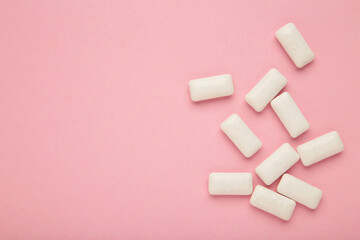 Chewing gum pieces on pink background. Space for text