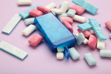 Different chewing gums on purple background.