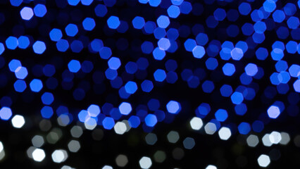 Blue and white bokeh on a dark background.