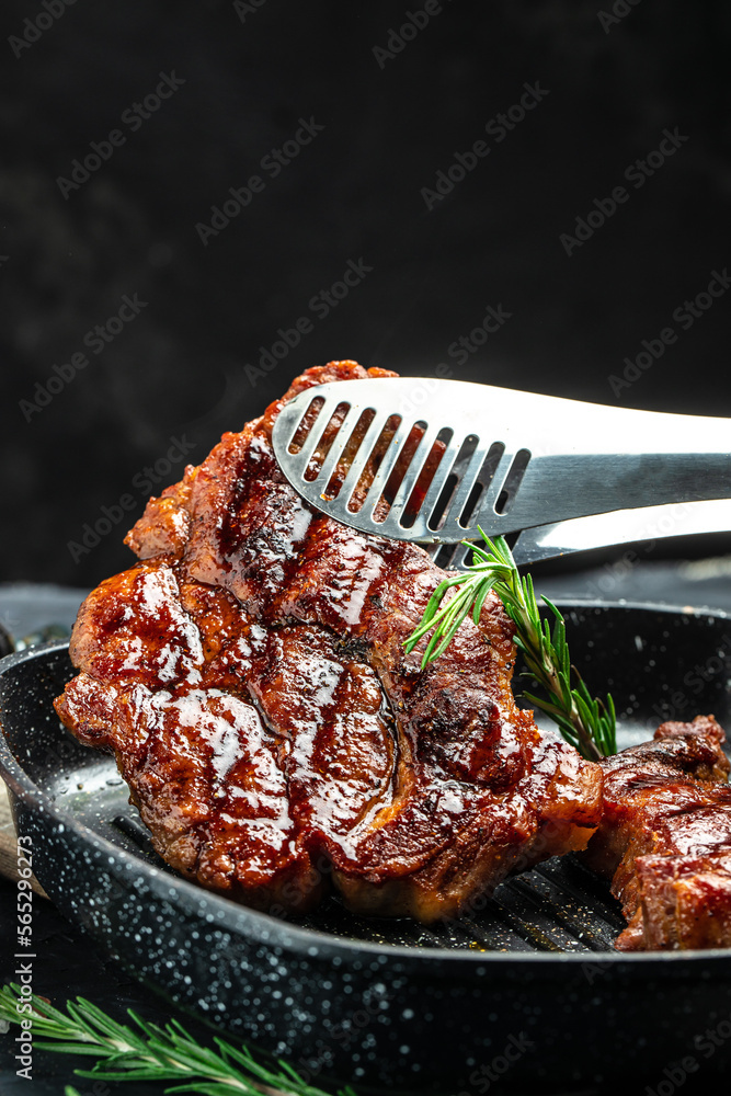 Wall mural grilled pork chops with herbs and spices. food recipe background. close up