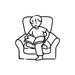 An adolescent boy reading a book on an armchair