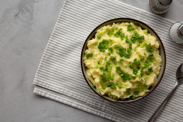 Homemade Mashed Potatoes with Chives in a Bowl, top view. Copy space.