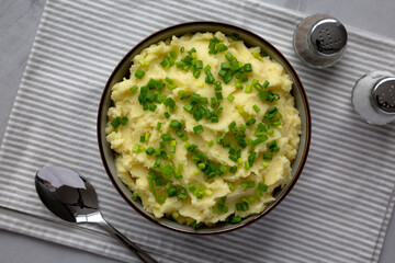 Homemade Mashed Potatoes with Chives in a Bowl, top view. Flat lay, overhead, from above.