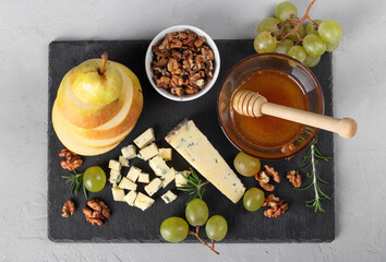 Ingredients for vegan dessert of pear, dor blue cheese, walnuts and honey