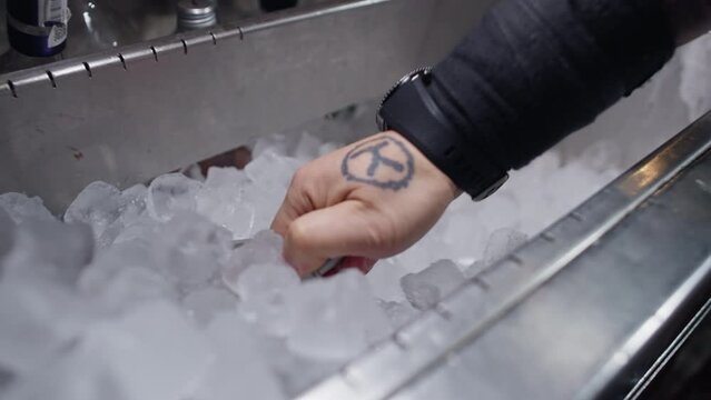 A slow-motion video of a bartender scooping up ice. The process of making cold cocktails at the bar. High quality 4k footage