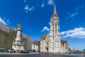 Fototapeta na wymiar Matthias Church, a church located in Budapest, Hungary, in front of the Fisherman's Bastion at the heart of Buda's Castle District. 