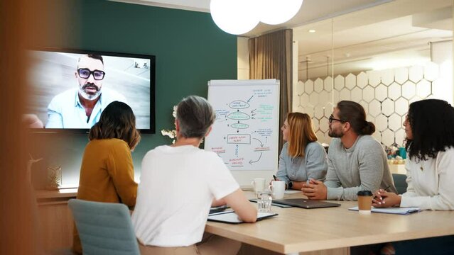 Group of working professionals engaging in a virtual meeting with a remote colleague, discussing a project together as a team. Business people vide calling an associate for a collaboration.
