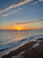 Fototapeta premium The sunsetting over the English Channel viewed from Brighton Beach, UK