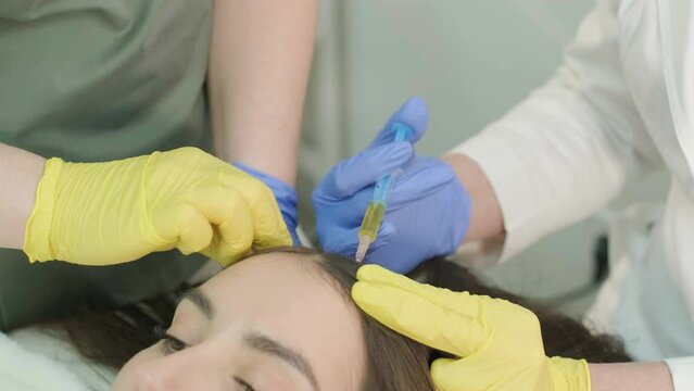 Plasma therapy of the scalp. Hair mesotherapy procedure in the modern cosmetology clinic