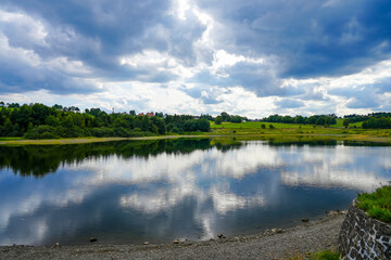 View of the landscape at the Stadtweger Teich near Clausthal-Zellerfeld in the Harz Mountains. Small lake in Lower Saxony. Mining pond with the surrounding nature.
