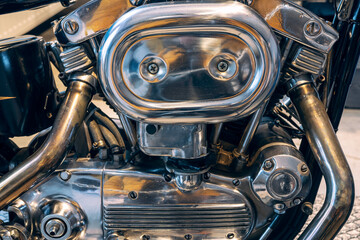 Fototapeta premium Fragment of v-twin engine in old-fashioned chopper. Chrome motor housing.