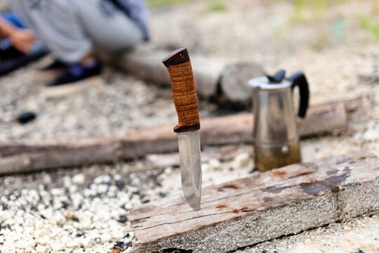 Knife stuck in piece of wood