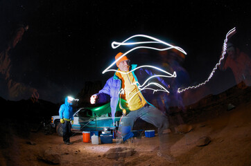Four men at a camp site at night.
