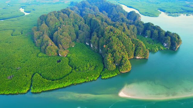 Beautiful estuary and amazing limestone mountain during sunset, Green mangrove forest surrounding the meandering river. Thailand. Stunning stock video footage. nature and travel concept.
