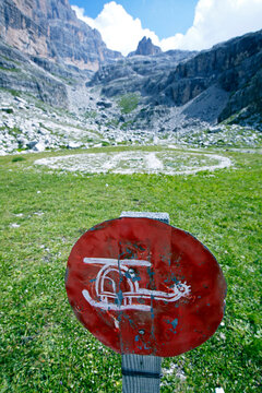 Rustic Sign Showing A Hand Painted Helicopter In Front Of A Helicopter Landing Spot In The Italian Dolomites Near Rifugio Brentei. Trentino, Italy.